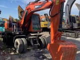 2023 Doosan DX150W wheel excavator, rear three-quarter view