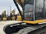 2023 Caterpillar 320 excavator, side view of cab and tracks