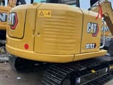 2023 Caterpillar 307E2 crawler excavator, rear three-quarter view