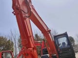 Hitachi ZX120 crawler excavator, low angle view of boom and cab