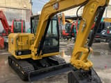 2023 Caterpillar 305.5E2 mini excavator, front three-quarter view
