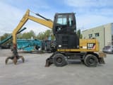 2009 Caterpillar M313D material handler, side view