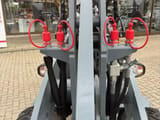2026 Giant G2500 HD Mini Excavator close-up of red hydraulic quick couplers on the gray loader arm
