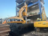2018 Caterpillar 320C amphibious excavator, rear three-quarter view