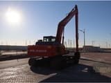 2025 Tata Hitachi EX215LC Crawler Excavator from the rear, highlighting the counterweight with the 'TATA HITACHI' branding.