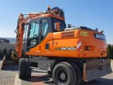 Doosan DX140W wheel excavator, rear three-quarter view