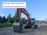 2026 Develon DX360LCA Crawler Excavator with its orange body, featuring a prominent view of the cab and operator station.