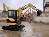 Caterpillar 303CR mini excavator, rear three-quarter view