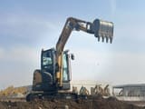 2025 SDLG ER636H excavator with its black digging bucket raised high, showing the full reach of the boom.