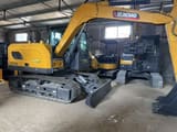 2025 XCMG XE75GA Mini Excavator with its boom and arm extended forward and a black dozer blade.