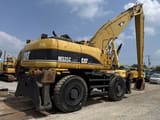 2005 Caterpillar M325C material handler, rear three-quarter view