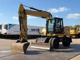 2012 Caterpillar M313D wheel excavator, front three-quarter view