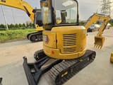 2024 Caterpillar 303.5E mini excavator rear three-quarter view