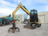 2009 Caterpillar M313D material handler, side view