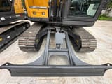 2026 XCMG XE75GA Mini Excavator showing a close-up view of the undercarriage and dozer blade.