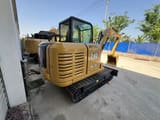 2024 Caterpillar 305.5E2 mini excavator, rear three-quarter view