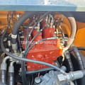 2026 Hyundai HX 245 Crawler Excavator, featuring a close-up of the hydraulic system components and hoses within the engine bay.