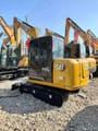 2025 Caterpillar 306 mini excavator, rear three-quarter view
