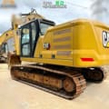 2023 Caterpillar 320 crawler excavator, rear three-quarter view
