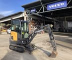 2022 Volvo JEC18E Mini Excavator with a dark gray boom and arm extending forward, featuring a standard digging bucket.