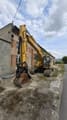2005 John Deere 200C LC crawler excavator, front three-quarter view
