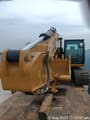 2025 Caterpillar 323D3 Crawler Excavator with a front view of the bucket and boom assembly.
