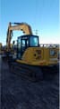 2021 Caterpillar 310-07 crawler excavator, rear three-quarter view