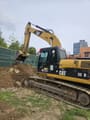 2012 Caterpillar 323DL crawler excavator side view