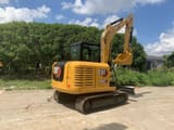 2023 Caterpillar 306E2 mini excavator, rear three-quarter view