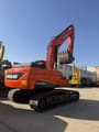 2024 Doosan DX225LCA crawler excavator, rear three-quarter view