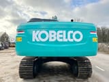 2025 Kobelco SK380XDLC-10 Crawler Excavator with a clear view of the teal counterweight and KOBELCO branding.
