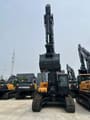 2026 Hyundai HX340HD Crawler Excavator showing the front of the cab and the raised dark grey bucket.