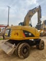 2023 Caterpillar M315D wheel excavator, rear three-quarter view