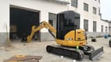 2023 Caterpillar 303.5E mini excavator, rear three-quarter view