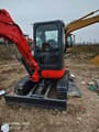 Kubota U25 Mini Excavator, front three-quarter view