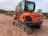 2018 Doosan DX55-9C excavator, rear three-quarter view