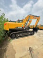 2025 Sany SY215H Crawler Excavator with its main body and boom in yellow, viewed from the rear right, highlighting the counterweight and