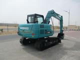 2025 Sunward SWE80E9 Mini Excavator, teal colored, displaying the rear counterweight with visible model markings.