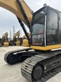 2023 Caterpillar 320 excavator, side view of cab and tracks