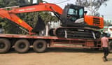 2025 Hitachi ZX220 Crawler Excavator with a close-up of the black track system and undercarriage.