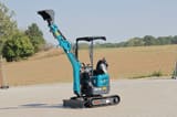 2025 Schmidt AR120 Mini Excavator, front three-quarter view, with the turquoise boom and arm raised high, displaying the bucket.