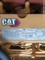 2025 Caterpillar 323D3 Crawler Excavator with a close-up view of the engine emission control information plate.