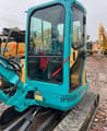 Kubota KX135 mini excavator, side view of the cab
