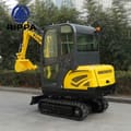 2026 Rippa R330 Mini Excavator from a front three-quarter angle, focusing on the black cab and the yellow engine cover.