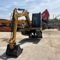 2024 Caterpillar 305.5E excavator, front three-quarter view