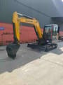 2026 LiuGong 906FG4 Mini Excavator with yellow boom and arm extended forward, featuring a standard digging bucket and dozer blade.