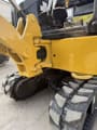 2022 Caterpillar 301.7 Mini Excavator close-up of the undercarriage and rubber tracks.