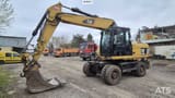 2010 Caterpillar M318D wheel excavator, front three-quarter view