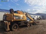 2008 Caterpillar M318D material handler, rear three-quarter view