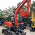 2023 Doosan DX55-9C mini excavator, rear three-quarter view